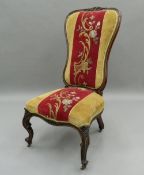 A Victorian rosewood framed tapestry covered nursing chair. 48 cm wide.