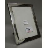 A silver photograph frame. 12.5 cm wide x 16.5 cm high.