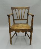 A Georgian elm solid seated country open armchair. 51.5 cm wide.