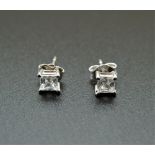 A pair of 14 K white gold stone set ear studs