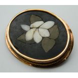 An unmarked gold mounted pietra dura brooch. 4.25 cm wide.