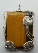 A silver and tigers eye pendant. 6 cm high.