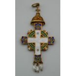A silver gilt enamel decorated cross form pendant, set with seed pearls, bearing Russian marks. 6.