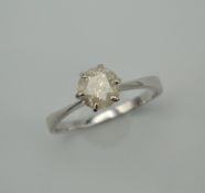 An 18 K white gold diamond solitaire ring. The stone approximately 1.25 carats. Ring Size V/W. 3.