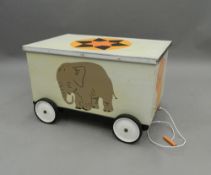 A wheeled wooden toy box. 72 cm long.