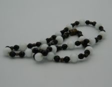 An Art Deco style glass bead necklace. 62 cm long.