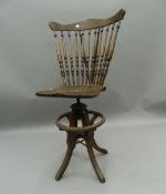 An early 20th century oak swivelling bar chair. 111.5 cm high.