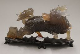 A carved jade model of a dragon. 21 cm long.