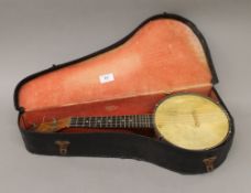 A Dulcetta banjo, cased. 55 cm long.
