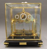 A Congreve type clock. 38 cm high.