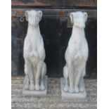 A pair of garden ornaments formed as greyhounds. 54 cm high.