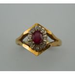 An 18 ct gold diamond and ruby ring. Ring Size O. 4.7 grammes total weight.