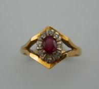 An 18 ct gold diamond and ruby ring. Ring Size O. 4.7 grammes total weight.