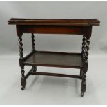 An early 20th century oak barley twist folding tea trolley/games table. 77.5 cm wide.