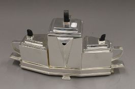 A silver plated Art Deco style tea set. 22 cm high.