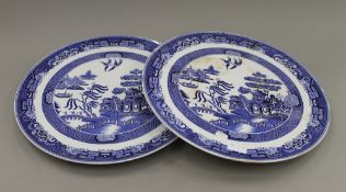 A pair of Willow pattern ceramic wall chargers. 43 cm diameter.