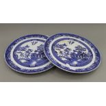 A pair of Willow pattern ceramic wall chargers. 43 cm diameter.