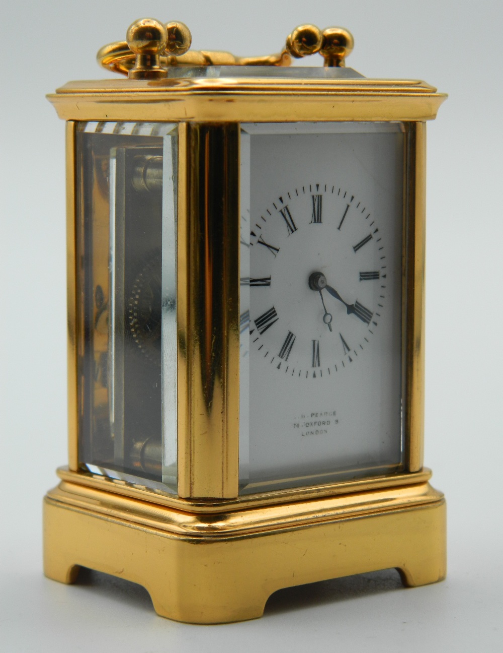 A miniature Antique carriage clock with brass and panelled glass case,