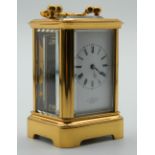 A miniature Antique carriage clock with brass and panelled glass case,