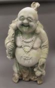 A large plaster model of a happy buddha. 89 cm high.