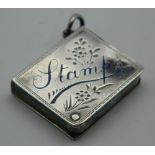 An enamel decorated silver stamp box. 3 cm high.