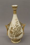 A large Royal Worcester gilt heightened twin handled vase. 46 cm high.