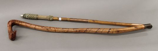 A walking stick with sailors ropework and silver band engraved S S Selria and a vintage carved