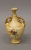 A Royal Worcester blush ivory twin handled vase. 18 cm high.