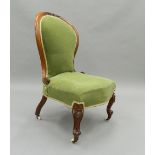 A Victorian mahogany spoon back nursing chair. 50 cm wide.