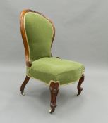 A Victorian mahogany spoon back nursing chair. 50 cm wide.