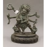 A multi-armed bronze deity. 24 cm high.