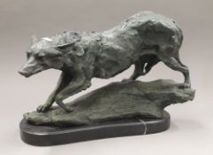 A patinated bronze model of a wolf. 42 cm wide.
