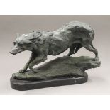 A patinated bronze model of a wolf. 42 cm wide.