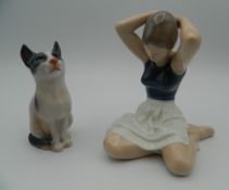 A Royal Copenhagen porcelain model of a ballerina and a cat. The former 12 cm high.