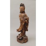 A 19th century Chinese wood carving of Guanyin. 54.5 cm high.