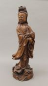 A 19th century Chinese wood carving of Guanyin. 54.5 cm high.