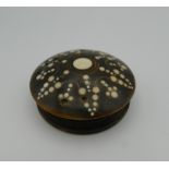 A 19th century horn inlaid snuff box. 6.5 cm diameter.