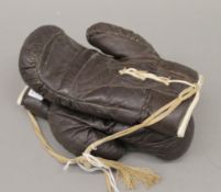 A pair of vintage boxing gloves. 23 cm long.