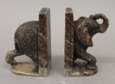 A pair of carved stone elephant formed bookends. 12 cm high.