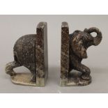 A pair of carved stone elephant formed bookends. 12 cm high.