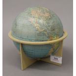 A small Phillips tin plate globe, on stand. 16 cm high.
