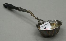 A Georgian silver toddy ladle, with turned wooden handle. 29 cm long.