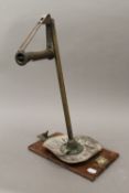 An unusual brass mounted compass/sighting device. 45 cm high.