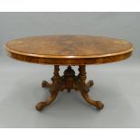 A Victorian inlaid walnut loo table. 133 cm wide.