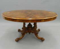 A Victorian inlaid walnut loo table. 133 cm wide.