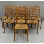 A set of eight early 20th century rush seated ladder back chairs. 43.5 cm wide.