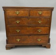 A Georgian cross banded oak chest of drawers. 105 cm wide x 96 cm high.