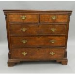 A Georgian cross banded oak chest of drawers. 105 cm wide x 96 cm high.