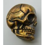 A brass vesta formed as a skull. 4 cm high.