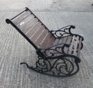 A cast iron garden rocking chair. 62 cm wide.